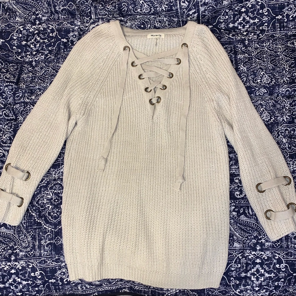 Cream sweater. Tie V neck.